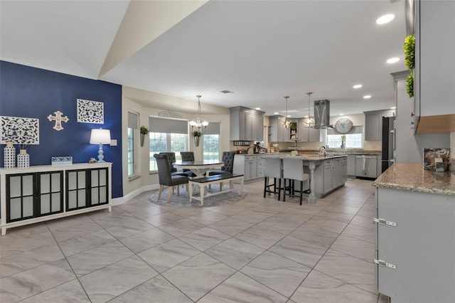 kitchen featuring island exhaust hood, gray cabinets, and plenty of natural light