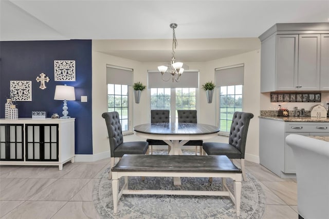 dining area with a healthy amount of sunlight and a notable chandelier