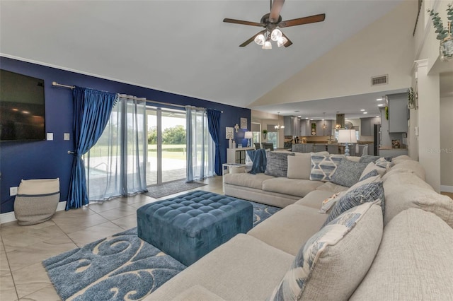 living room with ceiling fan and high vaulted ceiling