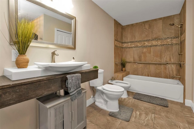 full bathroom with tiled shower / bath, vanity, toilet, and a bidet