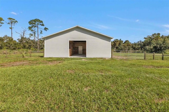 exterior space with an outdoor structure and a lawn