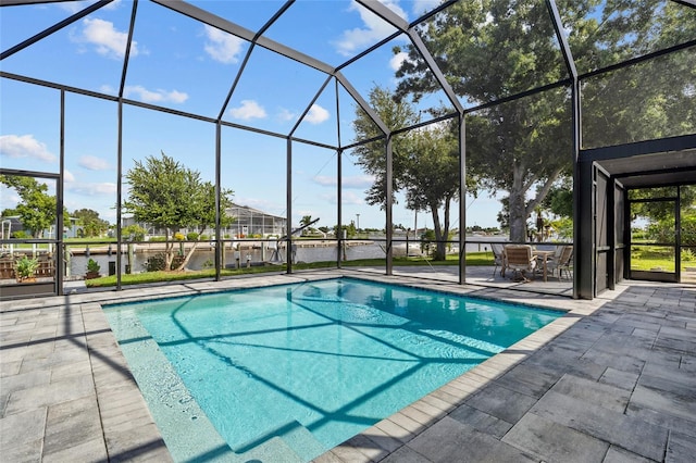 view of pool featuring glass enclosure, a patio, and a water view