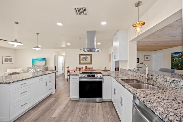 kitchen featuring island exhaust hood, appliances with stainless steel finishes, sink, and kitchen peninsula