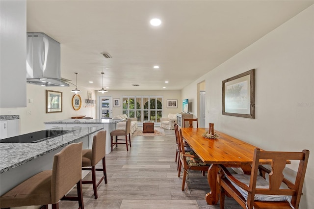 dining area featuring light wood-type flooring