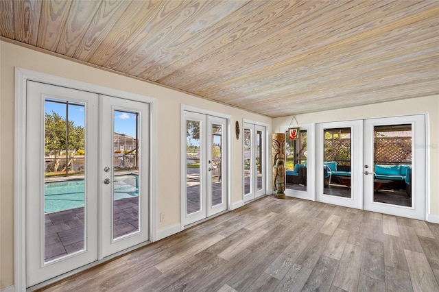 unfurnished sunroom featuring wood ceiling and french doors