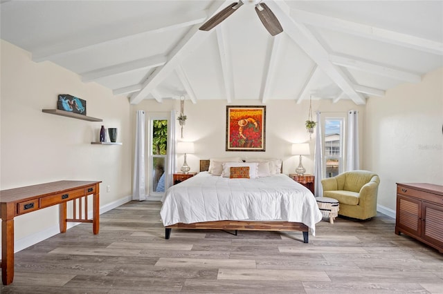 bedroom featuring light wood-type flooring, lofted ceiling with beams, and ceiling fan