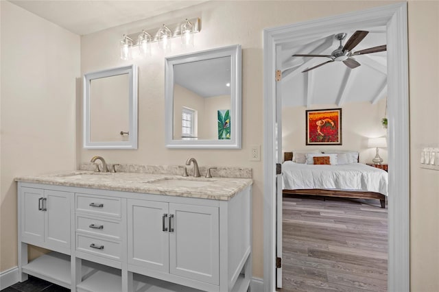 bathroom featuring ceiling fan, lofted ceiling with beams, wood-type flooring, and vanity