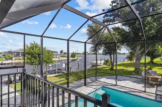 view of swimming pool with glass enclosure, a water view, a patio area, and a lawn