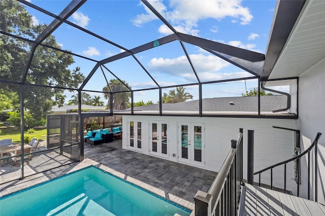 view of swimming pool featuring an outdoor hangout area, glass enclosure, a patio area, and french doors