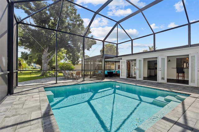 view of swimming pool featuring a patio and glass enclosure