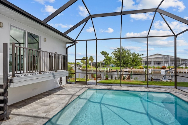 view of pool featuring a water view, a patio, and glass enclosure