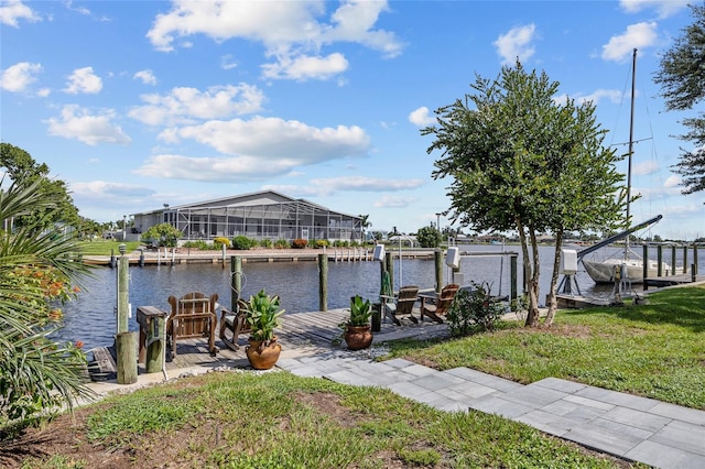 view of dock featuring a water view, a lawn, and a lanai