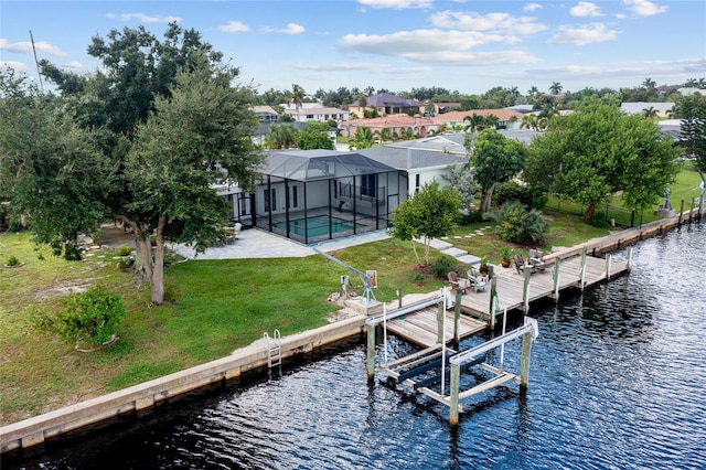 dock area with a water view, a yard, a lanai, and a pool