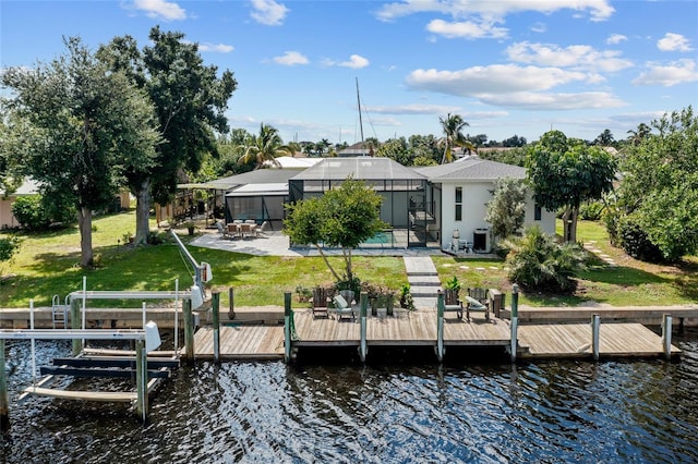 view of dock featuring a patio area, cooling unit, a yard, glass enclosure, and a water view