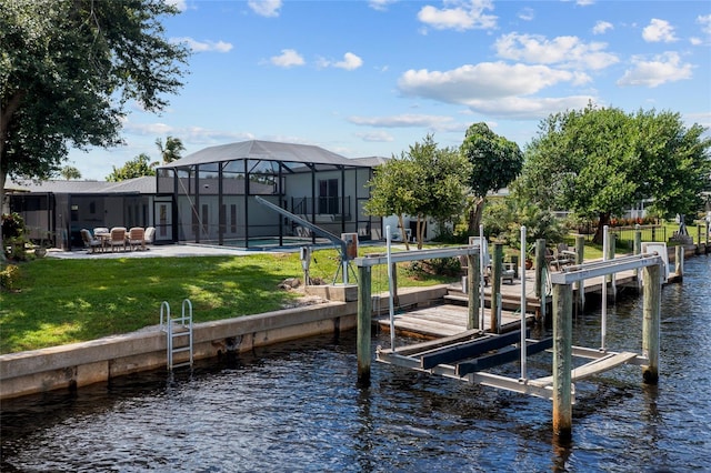 dock area with a yard, a lanai, a water view, and a patio area