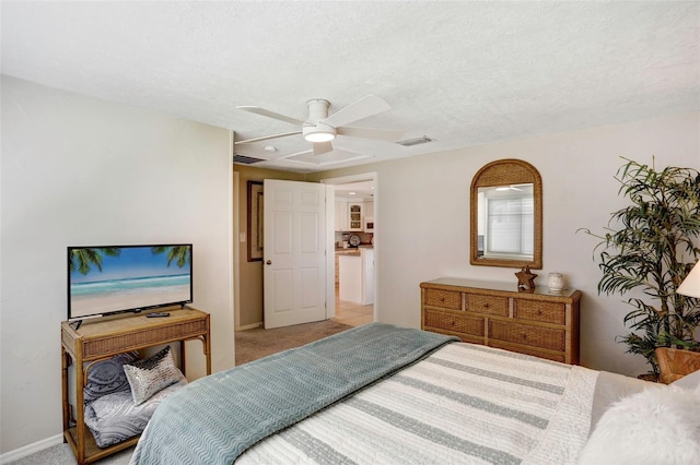 bedroom with carpet floors, a textured ceiling, and ceiling fan