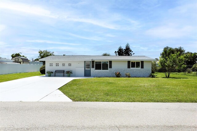 ranch-style house with a garage and a front lawn