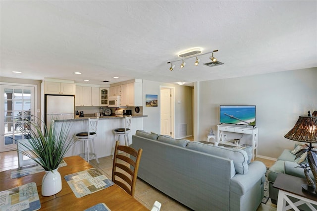 living room with light hardwood / wood-style floors and a textured ceiling