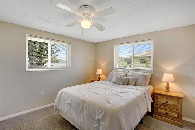 bedroom with a textured ceiling, carpet, and ceiling fan