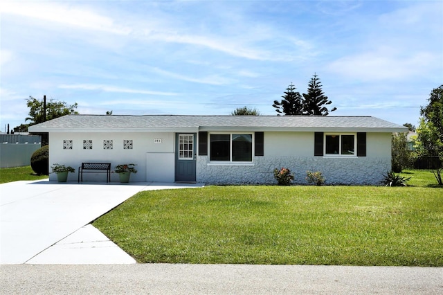 ranch-style home with a front yard and a garage