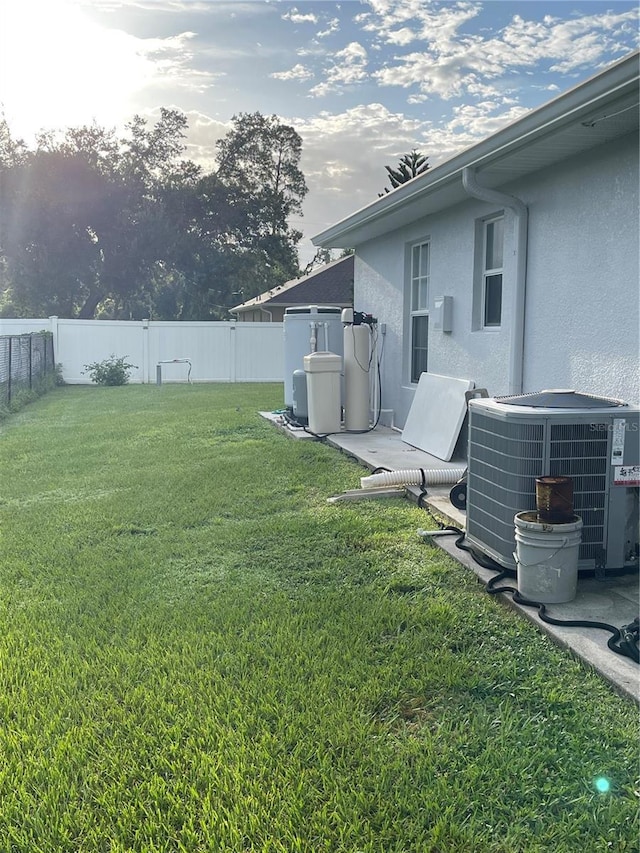 view of yard featuring central AC and a fenced backyard