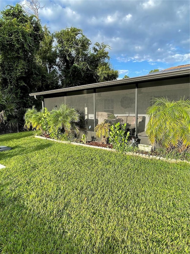 view of side of home with a lawn