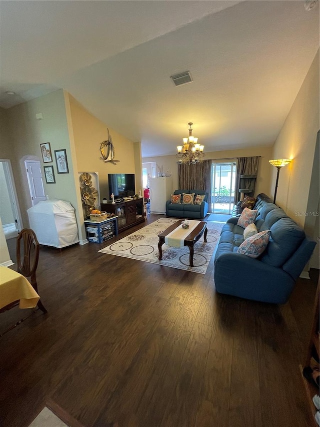 living room with lofted ceiling, an inviting chandelier, and dark hardwood / wood-style flooring