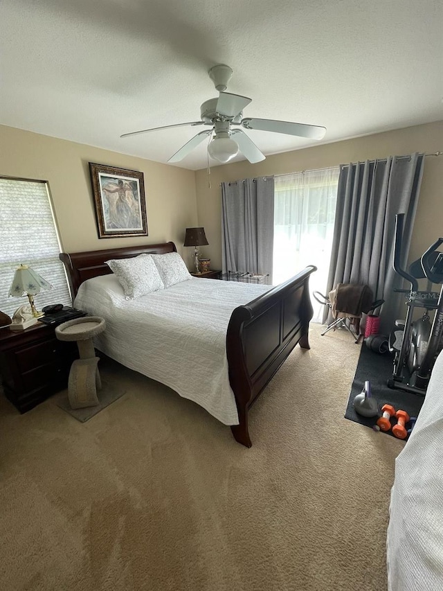 bedroom with a textured ceiling, ceiling fan, and carpet floors