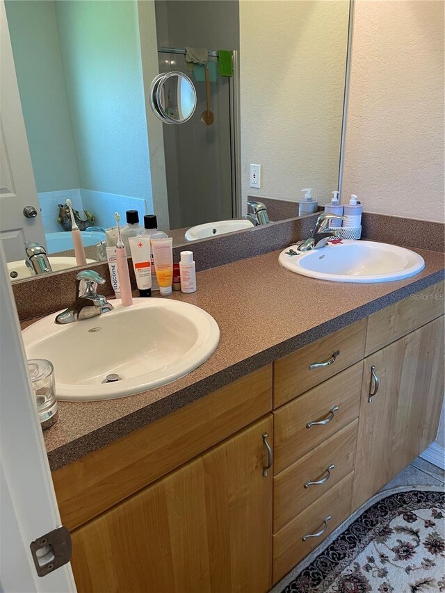2106 Switzerland Rd, North Port, FL 34288 - full bathroom featuring double vanity and a shower stall