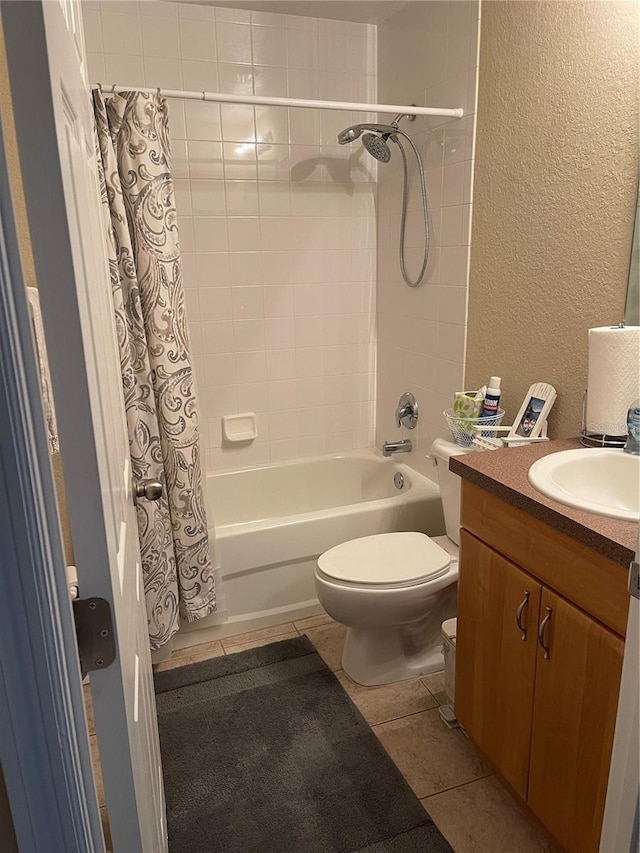 full bathroom featuring tile patterned floors, shower / bathtub combination with curtain, toilet, and vanity