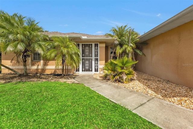 property entrance with a yard