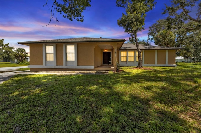 single story home featuring a yard