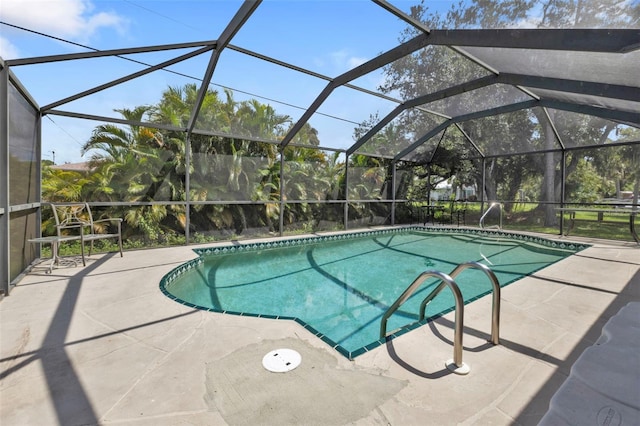 view of pool with a patio and a lanai