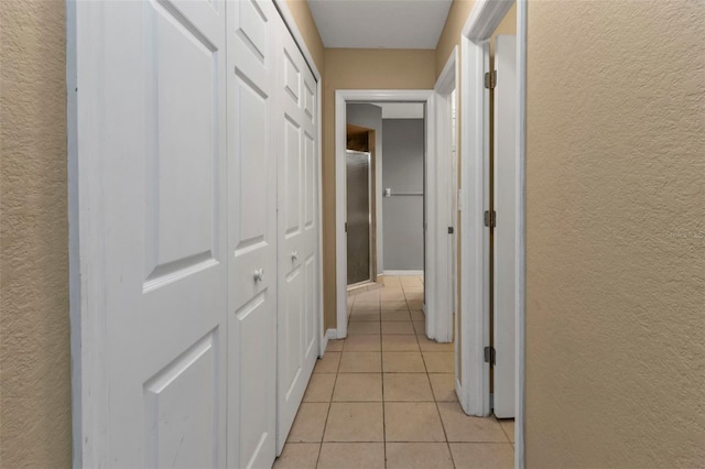 hallway featuring light tile patterned flooring