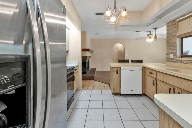 kitchen featuring light tile patterned flooring, hanging light fixtures, sink, stainless steel refrigerator with ice dispenser, and dishwasher