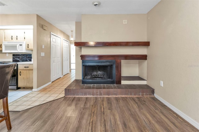 unfurnished living room with light wood-type flooring