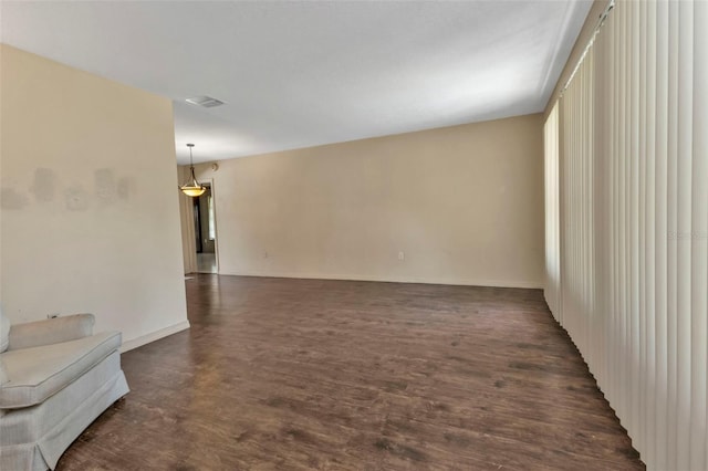 spare room with dark wood-type flooring