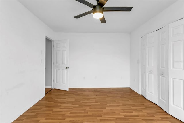 unfurnished bedroom with ceiling fan, a closet, and light hardwood / wood-style floors