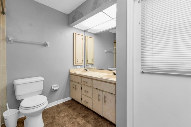 bathroom with tile patterned flooring, vanity, and toilet