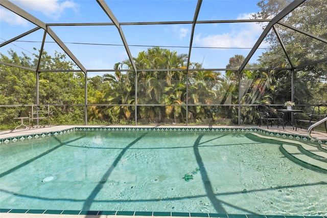 view of swimming pool with glass enclosure