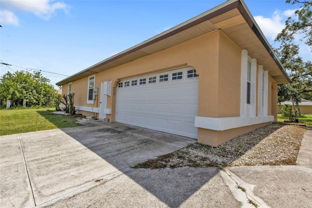 view of home's exterior featuring a lawn and a garage