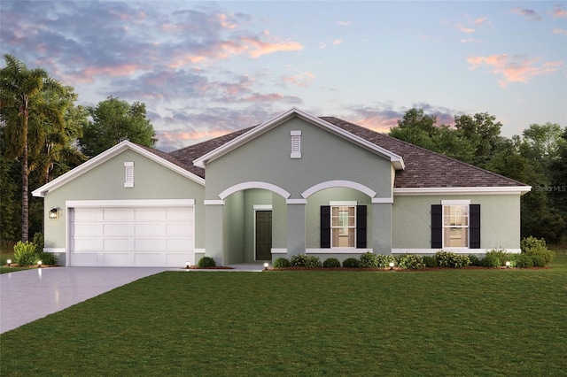 view of front of property featuring driveway, a garage, a front yard, and stucco siding