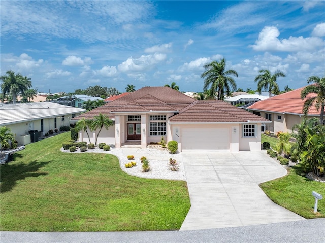 mediterranean / spanish-style house with a garage and a front lawn