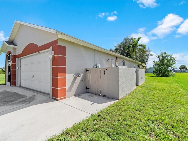 view of property exterior featuring a garage and a lawn