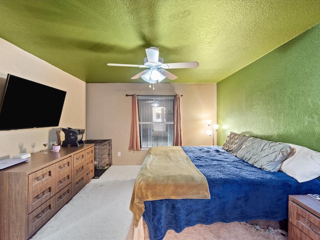 carpeted bedroom featuring a textured ceiling and ceiling fan