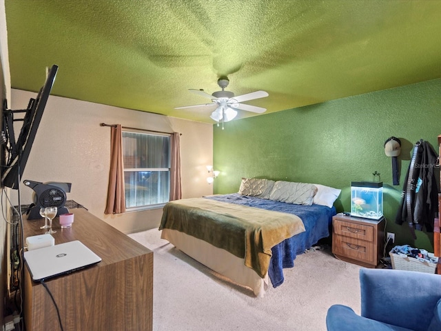 bedroom with a textured ceiling, light colored carpet, and ceiling fan