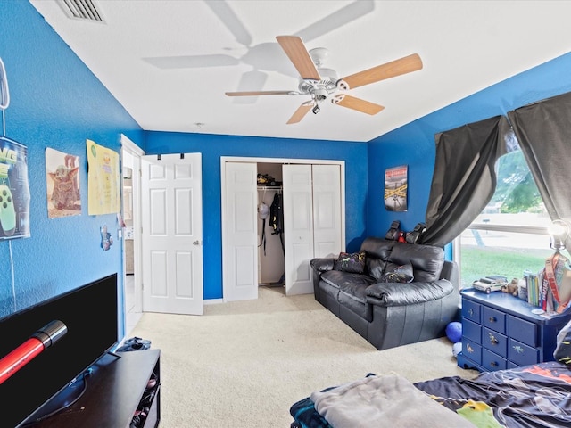 carpeted bedroom featuring a closet and ceiling fan