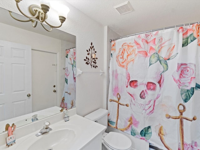 bathroom featuring vanity, toilet, a shower with shower curtain, and a textured ceiling