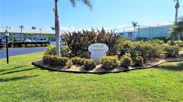 community sign featuring a yard