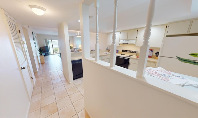 kitchen with white appliances, light tile patterned floors, and a textured ceiling